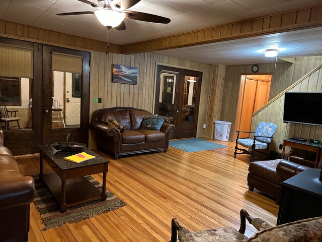 9516 State Highway M64, Marenisco, MI 49947 - living area featuring a ceiling fan, wooden walls, and wood finished floors