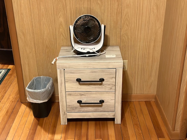 room details featuring hardwood / wood-style flooring and wood walls