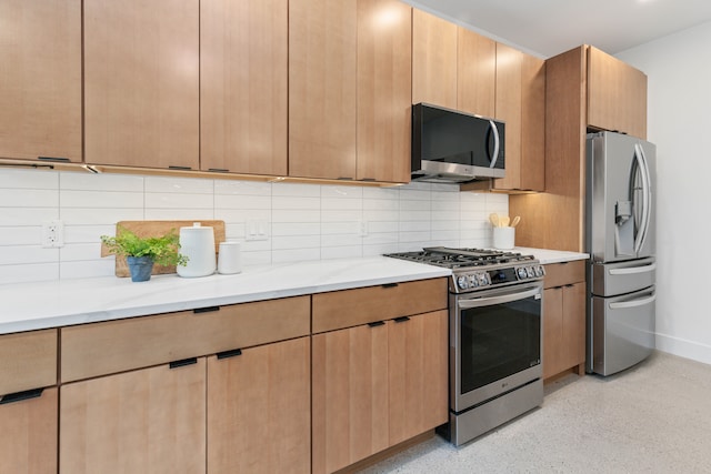 kitchen with light stone countertops, light brown cabinetry, backsplash, and stainless steel appliances