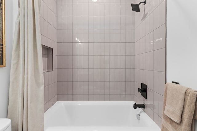 bathroom with toilet and shower / tub combo with curtain