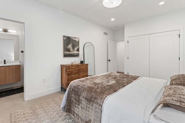 bedroom with light carpet and a closet