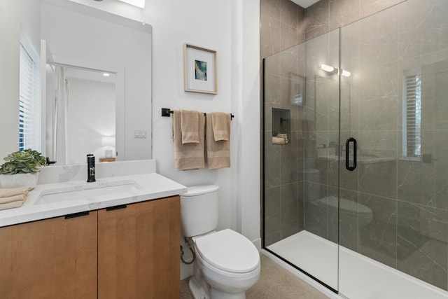 bathroom with vanity, an enclosed shower, and toilet