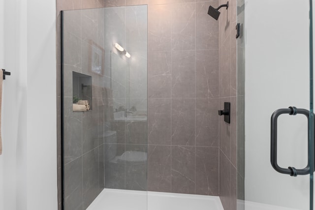 bathroom with a shower with shower door