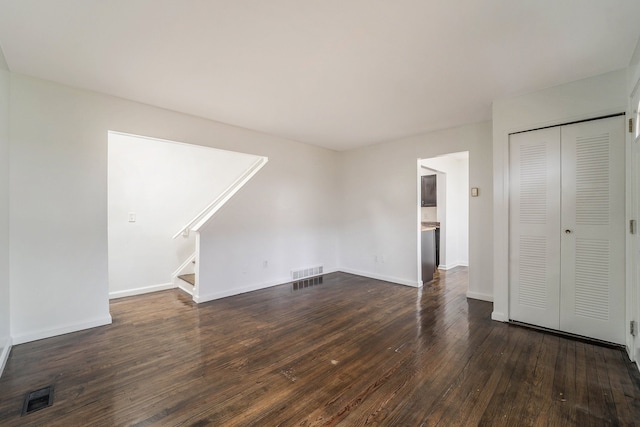 unfurnished living room featuring dark hardwood / wood-style floors