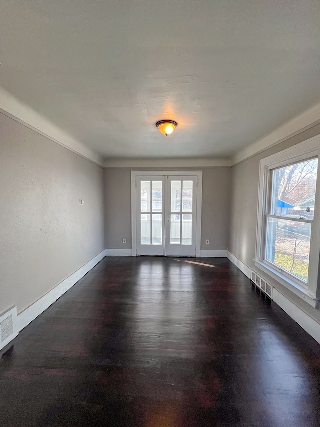 spare room with dark wood-type flooring