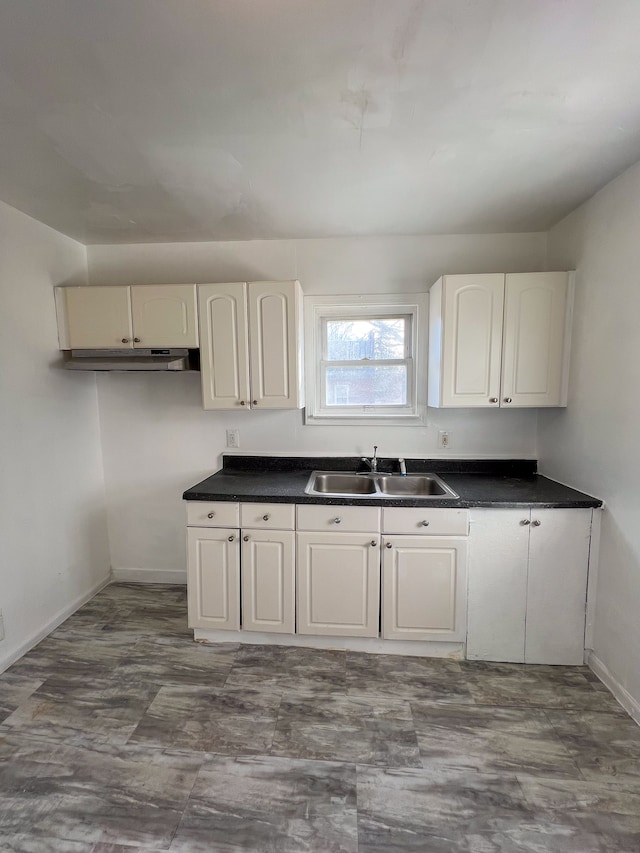 kitchen featuring sink and white cabinets