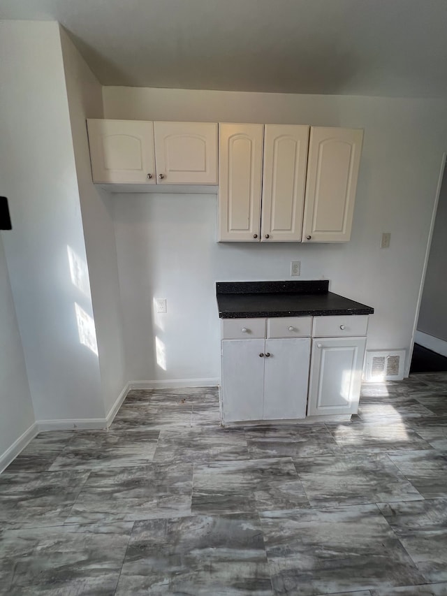 kitchen featuring white cabinetry