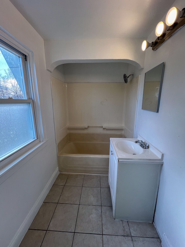 bathroom with tile patterned floors, vanity, and washtub / shower combination