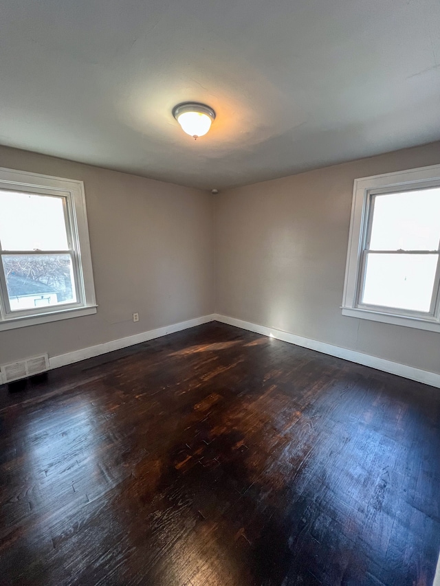 empty room featuring dark hardwood / wood-style flooring