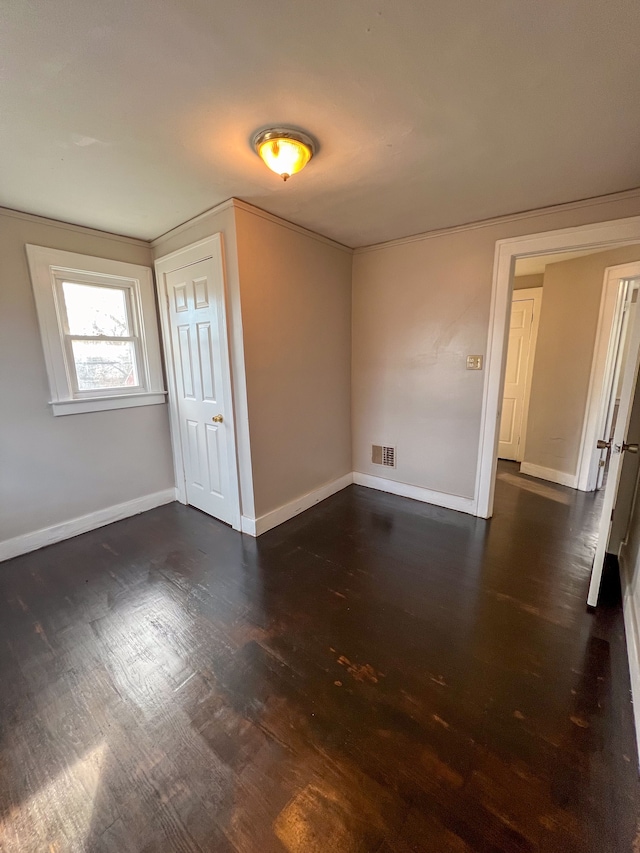 spare room featuring dark wood-type flooring