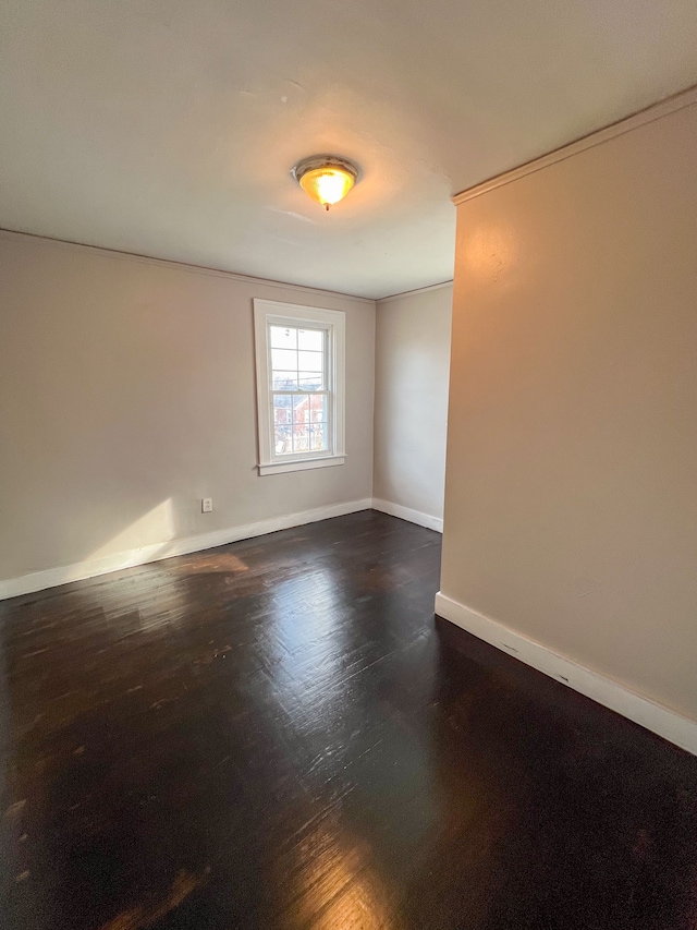 unfurnished room with dark hardwood / wood-style flooring