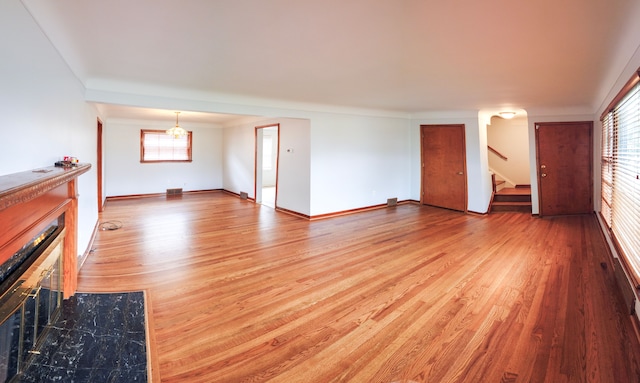 unfurnished living room with wood-type flooring and a wealth of natural light