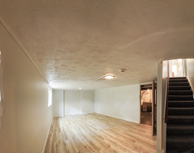 basement with light hardwood / wood-style floors