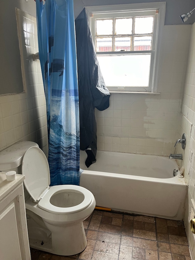 full bathroom with vanity, shower / bathtub combination with curtain, tile walls, and toilet