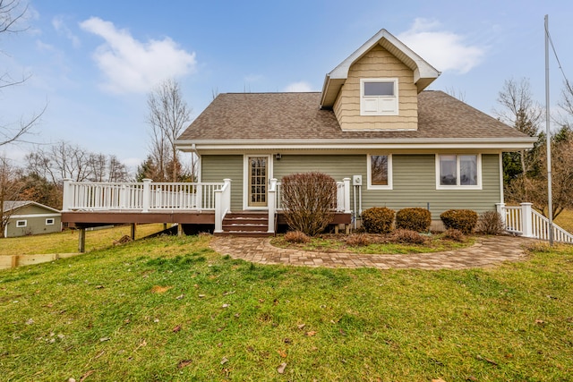 view of front facade with a deck and a front lawn