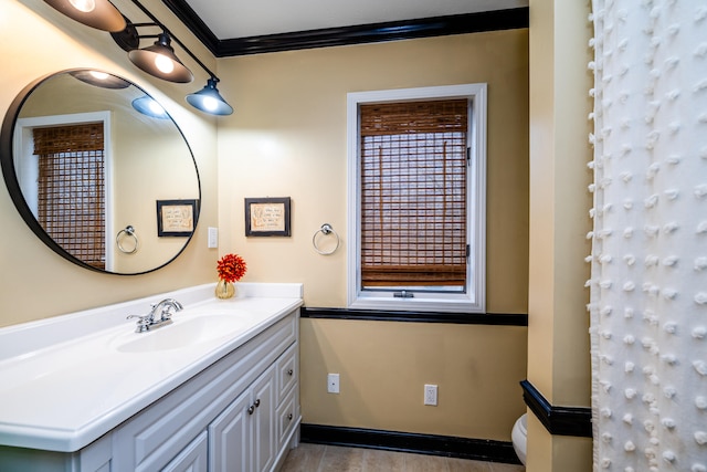 bathroom with vanity and ornamental molding