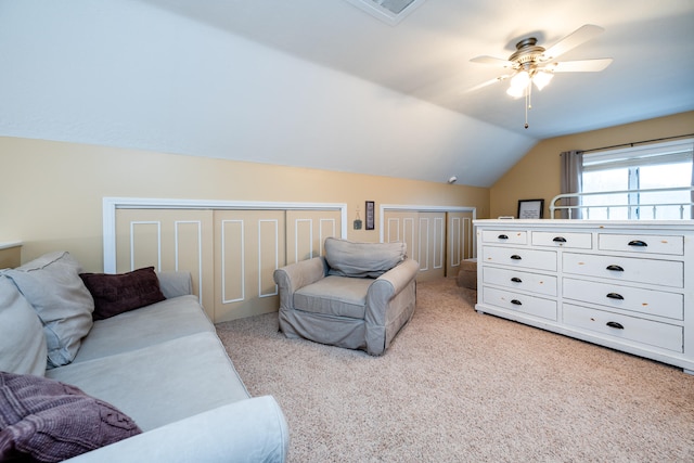 interior space featuring multiple closets, ceiling fan, and lofted ceiling