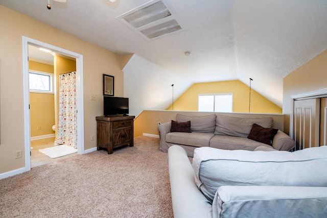 carpeted living room featuring vaulted ceiling