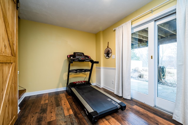 exercise area with dark wood-type flooring