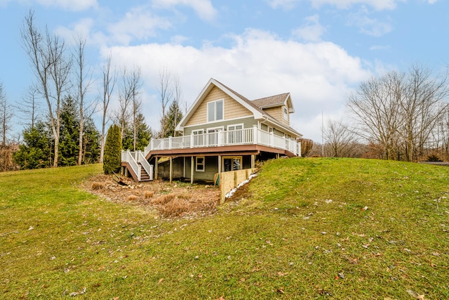 back of property featuring a wooden deck and a yard