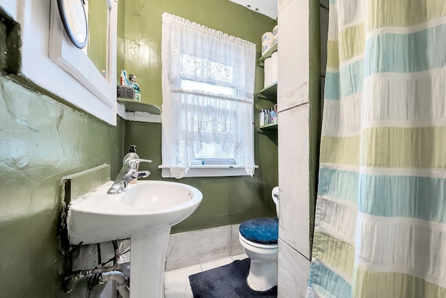 bathroom featuring tile patterned flooring and toilet