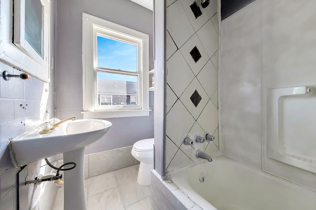776 Woodmere St, Detroit, MI 48209 - bathroom featuring tile walls, toilet, bathtub / shower combination, and marble finish flooring