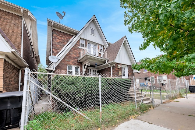 776 Woodmere St, Detroit, MI 48209 - view of front facade with a gate, board and batten siding, and brick siding