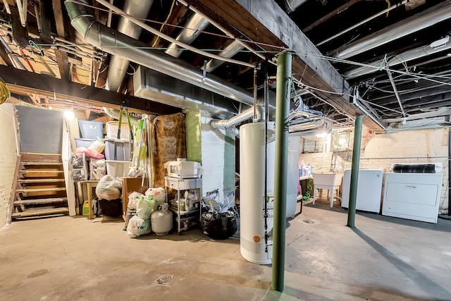 basement with washer and dryer, sink, refrigerator, and water heater