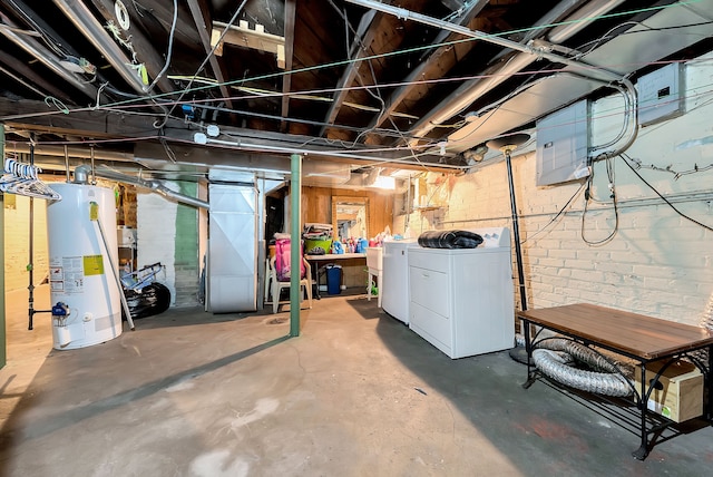 basement featuring washing machine and dryer and water heater