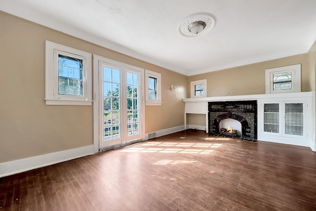 unfurnished living room featuring a fireplace and hardwood / wood-style flooring