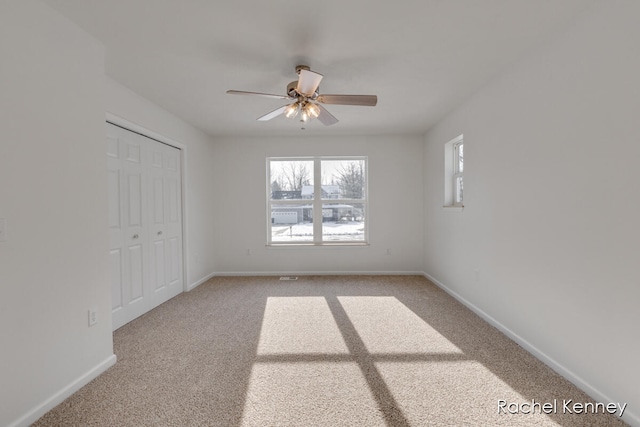 unfurnished room with light carpet and ceiling fan