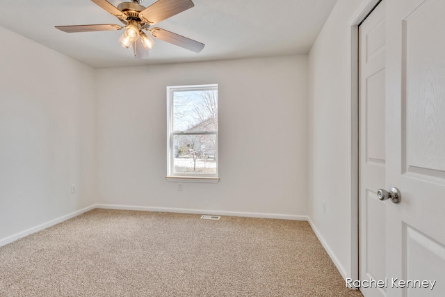 spare room with ceiling fan and carpet floors