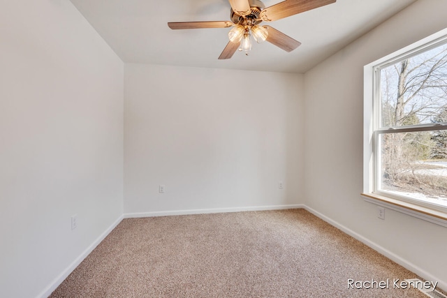 carpeted spare room with ceiling fan and a healthy amount of sunlight