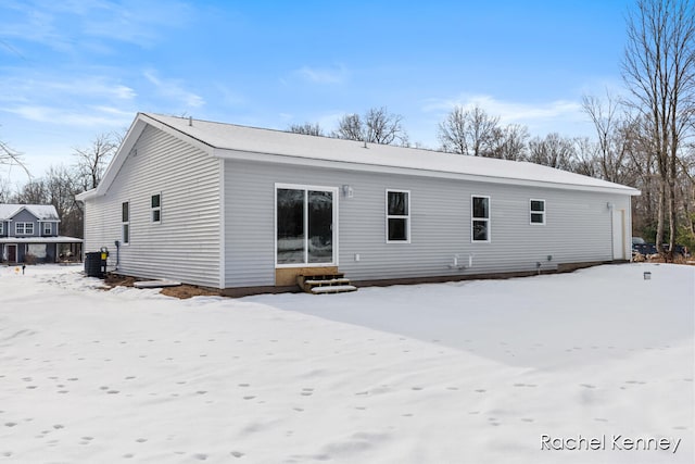 snow covered house with central AC