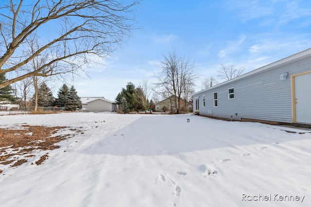 view of yard layered in snow