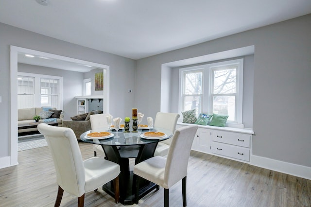 dining space with light hardwood / wood-style floors