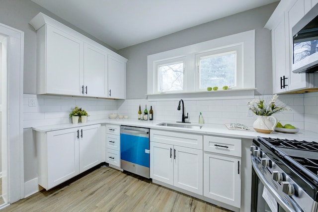 kitchen featuring sink, white cabinets, and appliances with stainless steel finishes