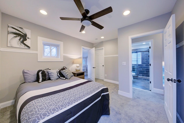 bedroom with a closet, connected bathroom, light colored carpet, and ceiling fan