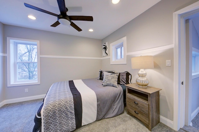 bedroom featuring ceiling fan and light carpet