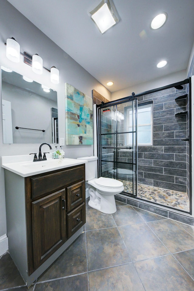 bathroom featuring vanity, an enclosed shower, and toilet