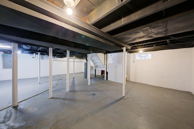 basement with electric panel and water heater