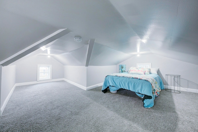 carpeted bedroom featuring lofted ceiling