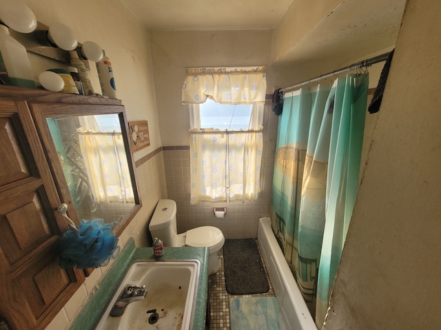 full bathroom with sink, shower / bath combo with shower curtain, tile walls, and toilet