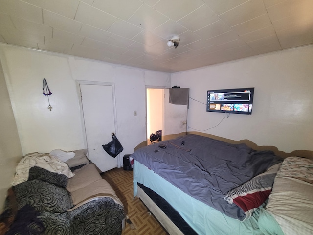 bedroom with dark parquet flooring