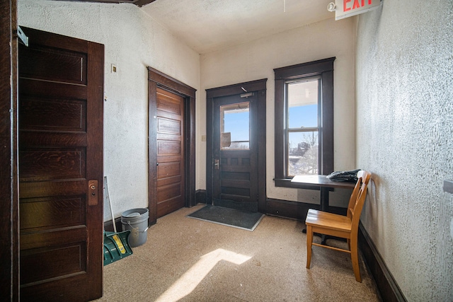 foyer entrance with light carpet