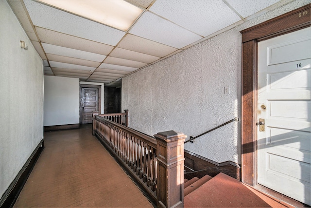 hall featuring a drop ceiling