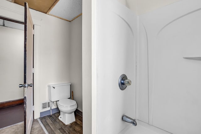 bathroom with hardwood / wood-style floors and toilet