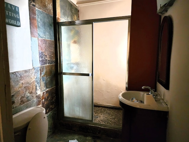 bathroom with vanity, toilet, and a shower with door