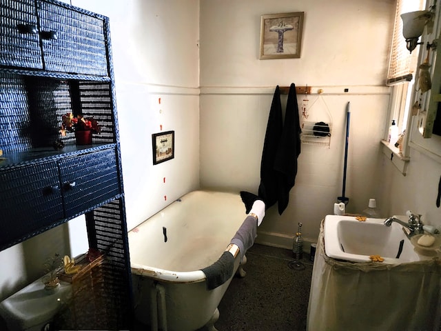 bathroom featuring a tub to relax in and sink