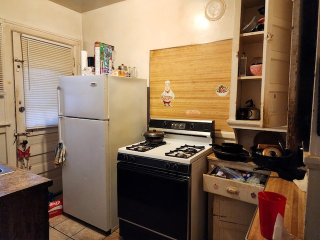 kitchen featuring white appliances and light tile patterned floors